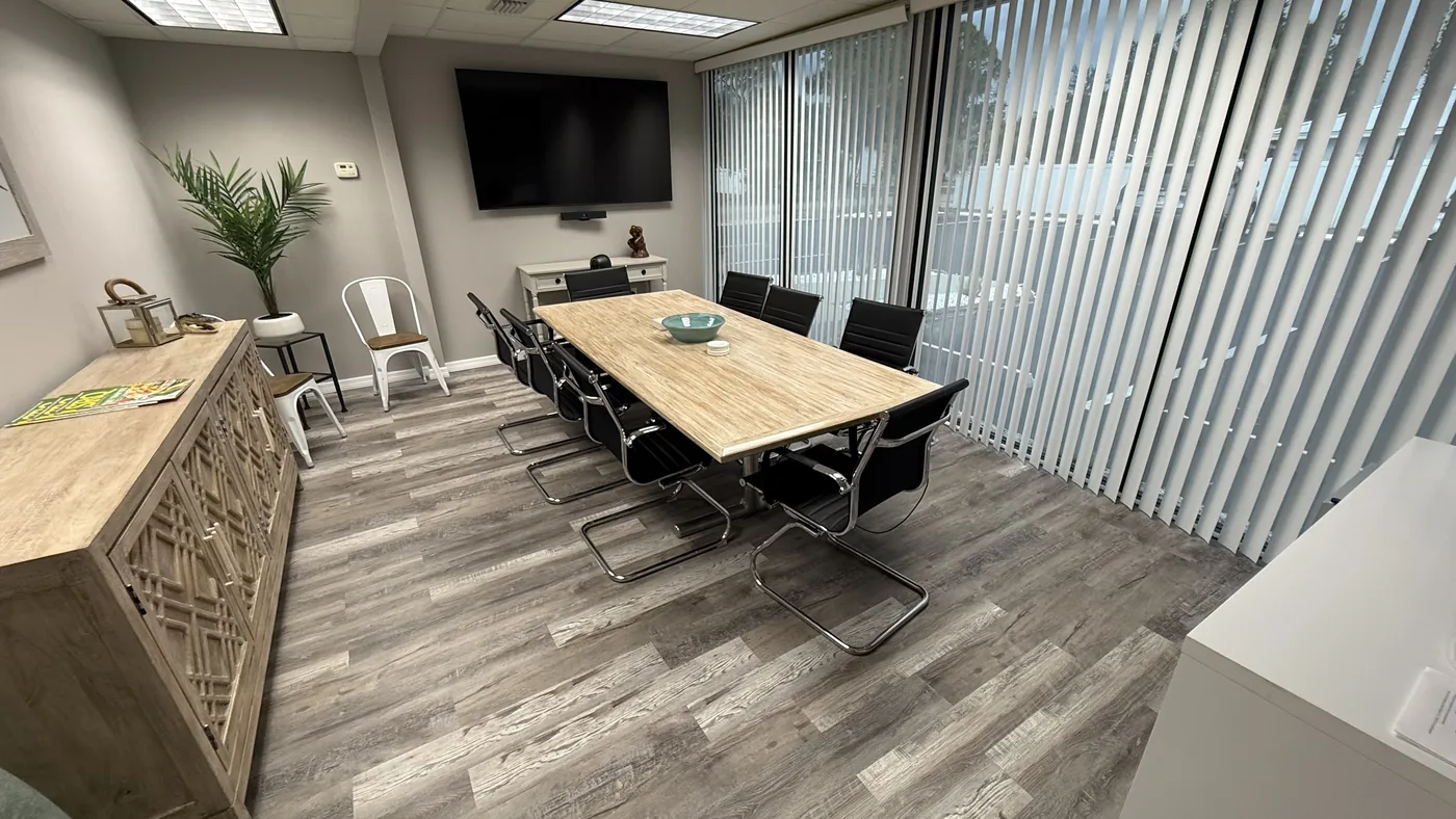 Conference room with a large table and seating for eight.
