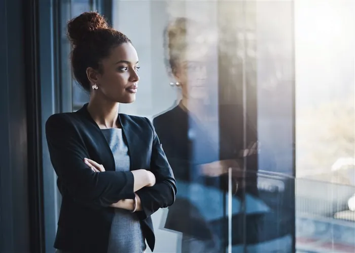 Businesswoman looking out the window &mdash; a real Sarasota address for Google Business Profile.
