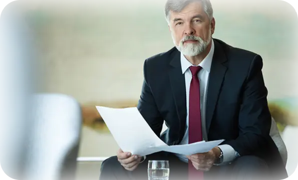Senior mediator with documents at a professional session.