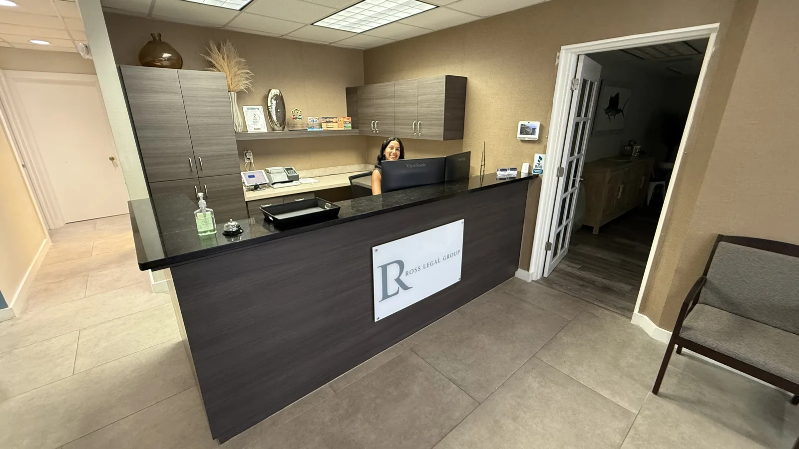Reception desk and front lobby at Hibiscus Executive Suites, with staff on hand.